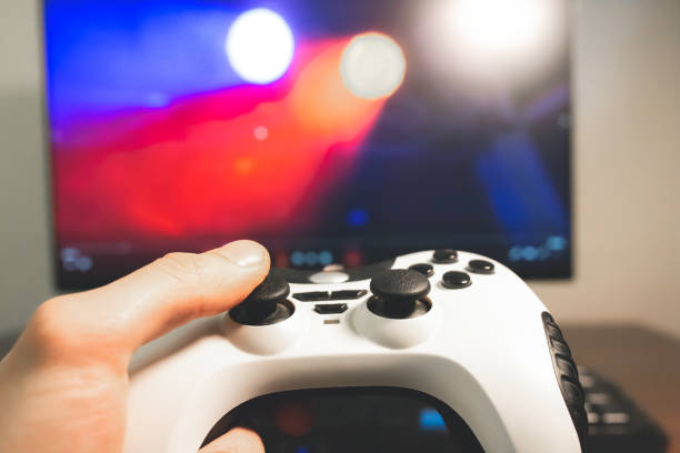istock Man is playing video games at home. Gamepad in hands. Self isolation time. Entertainment during the quarantine period. 1264134375