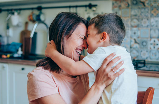 istock Affectionate mother and son embracing at home. 1264134863