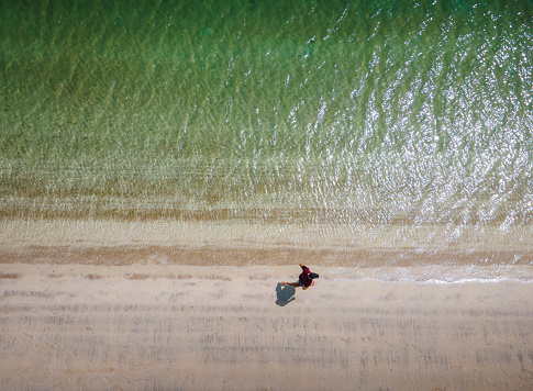 Man running on the beach aerial view with large copy space