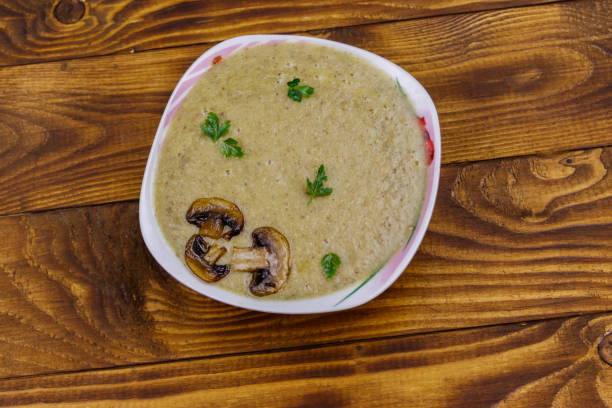 istock Mushroom cream soup on a wooden table. Top view 1264136034