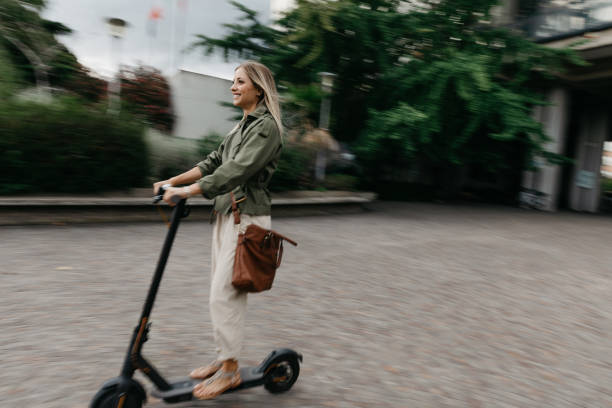 istock Green mobility in the city; woman commuting to work 1264137745