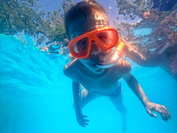 istock A little boy dives in the pool 1264139106