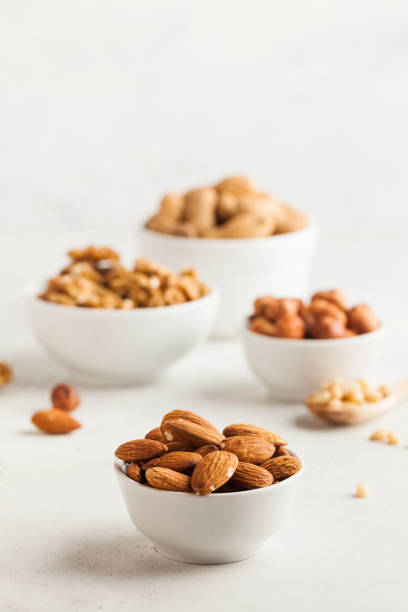 istock A handful of almonds in a white bowl, assorted nuts on a light background. Healthy snacks, healthy fats. Copy space. 1264139570