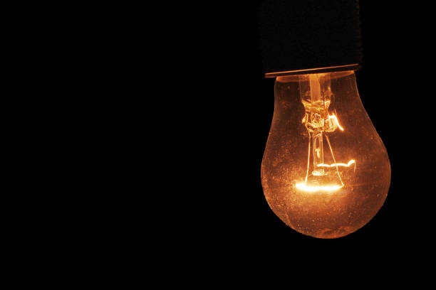 istock incandescent lamp burning in the dark 1264140954