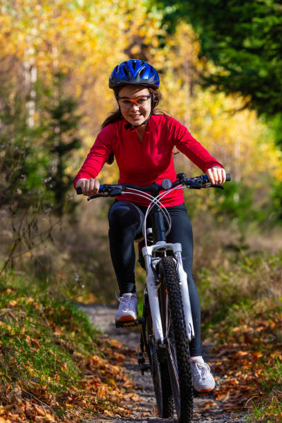 istock Girl riding bike on forest trails 1264141029