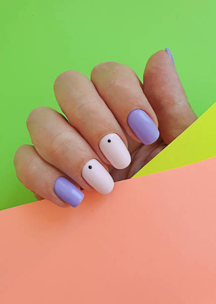 istock female hand stylish beautiful manicure on a colored background 1264141076