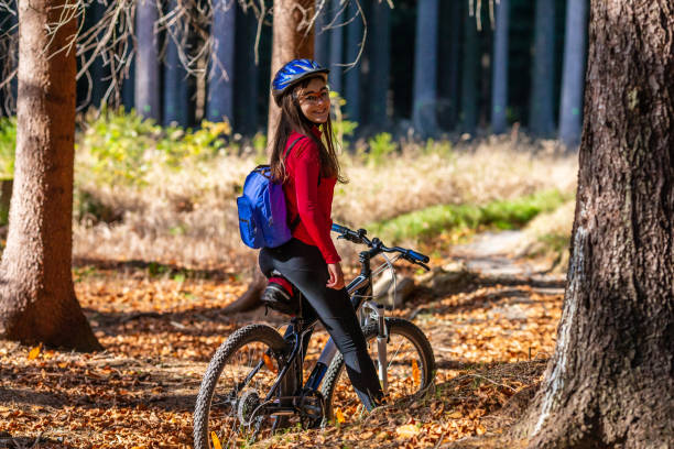 istock Girl riding bike on forest trails 1264141328