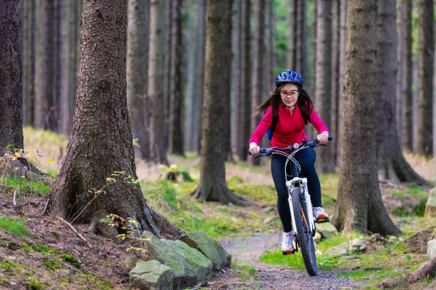 istock Girl riding bike on forest trails 1264141992