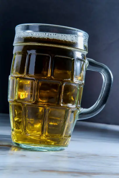 Closeup beer mug with amber color on marble table