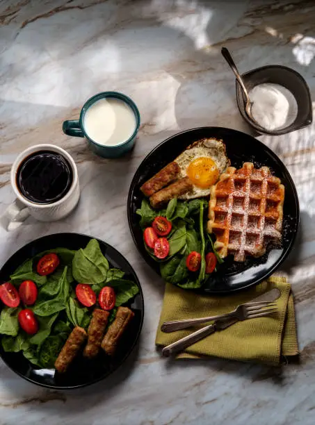 Belgian waffle breakfast served with sausage eggs and coffee