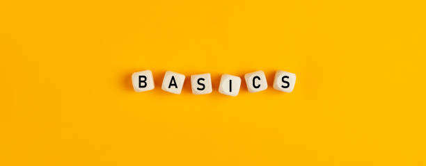 Basics word written on wood blocks on yellow background with flat lay view Basics word written on wood blocks on yellow background with flat lay view. Back to basics or simplifying business concept. simple living stock pictures, royalty-free photos & images