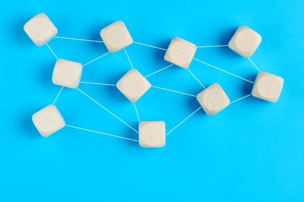 Blank empty wooden blocks linked to each other with lines on blue background. Concept of network, organization, communication, interaction or collaboration.