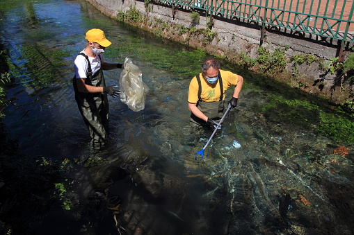 Sarno,Sa,Italy - July 26,2020 :In the bed of the Rio Palazzo , a tributary of the River Sarno, the volunteers of Leonia circle Legambiente Sarno Valley , in more than four hours of work have collected different material thrown so uncivilized on the banks and in the bed of the Rio . Glass bottles, plastic cans, and really unusual material as part of a TV screen and finally part of a lighting pole of the nearby public garden .