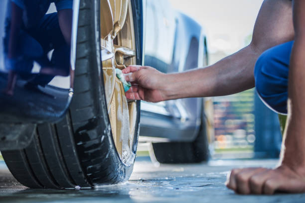 istock Cleaning Exotic Car Golden Alloy Wheels 1264145846