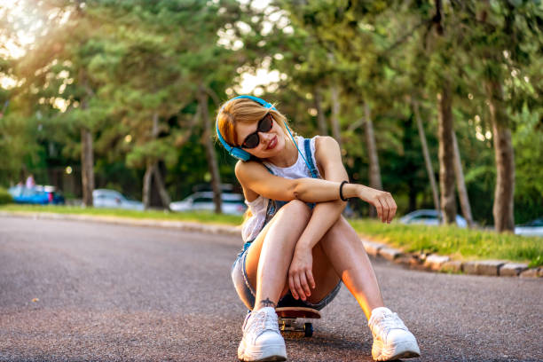 istock Young woman skateboarder at skate park 1264147552