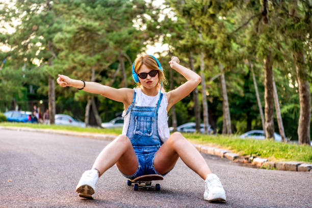 istock Young woman skateboarder at skate park 1264148519