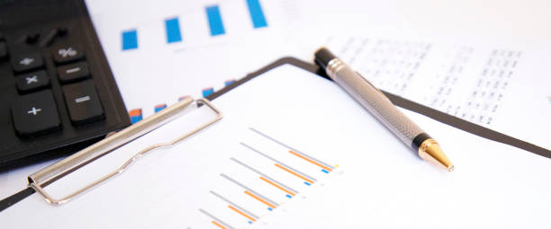 istock Graphics on a white background with a calculator and a pen. 1264148809