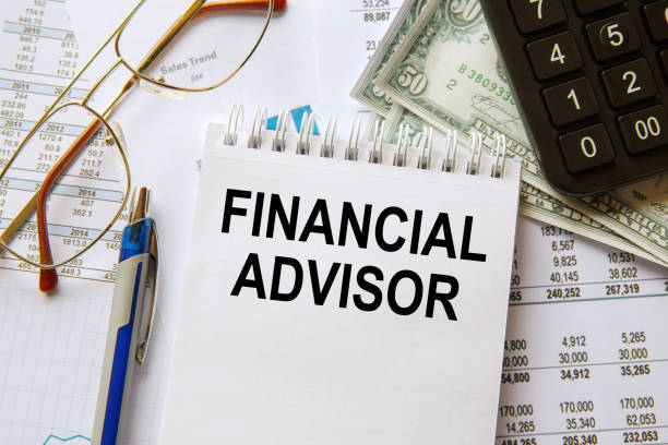 istock Financial Advisor is written on a notepad on an office desk 1264150063