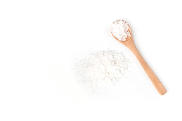istock Sea salt on wooden spoon isolated on white background 1264151055