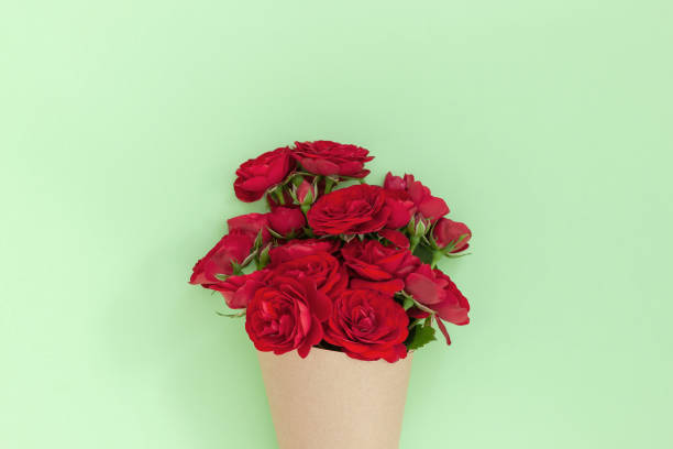 istock Red rose bouquet wrapped vintage craft paper. 1264151138