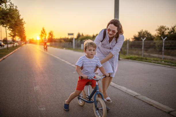 istock Mother teaching her son biking 1264151243
