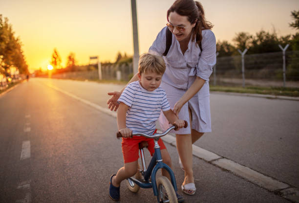 istock Mother teaching her son biking 1264151327