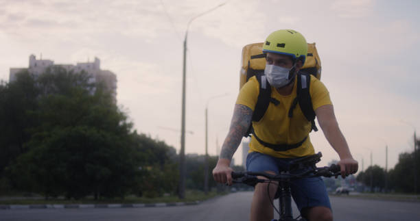istock Bicycle messenger cycling on a road 1264152370