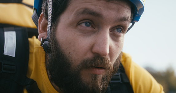 Close-up of a tired delivery man looking at camera
