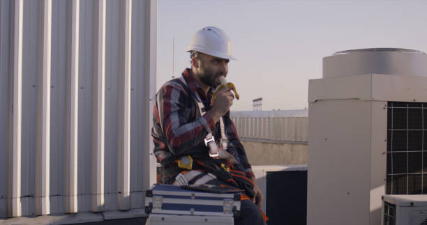 istock Engineer eating a banana during his break 1264152530