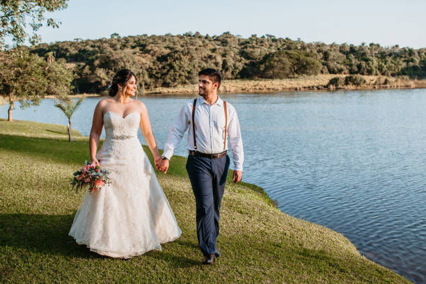 istock bride and groom walking together 1264154057