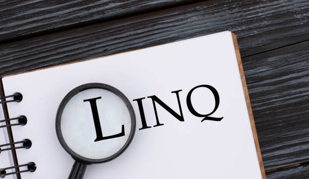 istock LINQ word written in a notebook on a dark beautiful background with a magnifying glass 1264154108