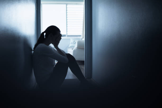 istock Sad woman sitting on the floor at home. 1264155341