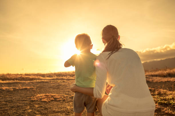 Mother and son watching beautiful sunset