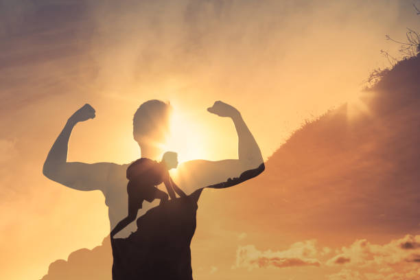 istock Strong man climbing up a mountain never giving up. 1264155421