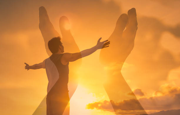 istock Man with arms outstretched looking up to the sunset sky. 1264156677