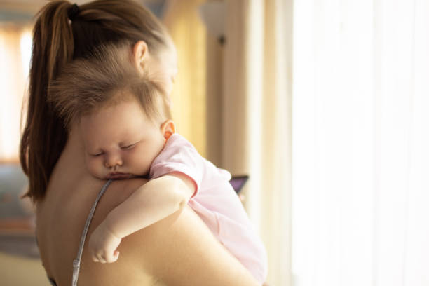 istock Mother putting her baby to sleep. 1264156787