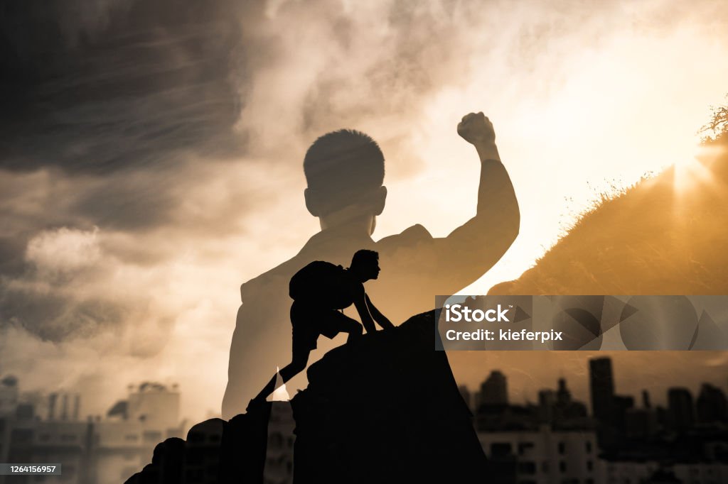 Young man in the city reaching his goals. People inspiration and never giving up concept Success Stock Photo