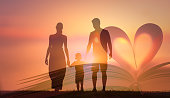 istock Family walking at sunset. 1264157144