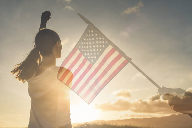 istock Strong woman waving American flag. 1264157244