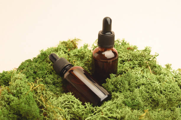 istock Two serum glass bottles with pipette on the moss. 1264162784