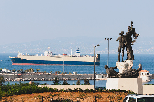A vehicle carrier is seen off the coast of Beirut, Lebanon. The Martyrs Square monument (foreground) honors people executed here in 1916 at the orders of the Ottoman military ruler Jamal Pasha. (Photo taken on August 30, 2010)