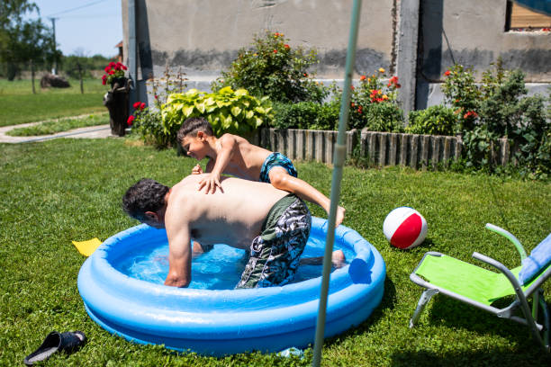 istock A boy climbing onto his grandfather's back in an inflatable pool 1264165848