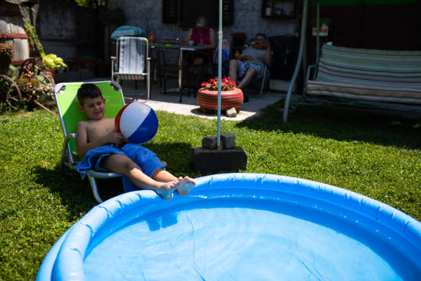 istock A boy relaxing next to an inflatable pool 1264165857
