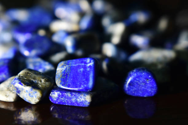 istock Lapis Is a beautiful natural gemstone on a wooden floor 1264166683