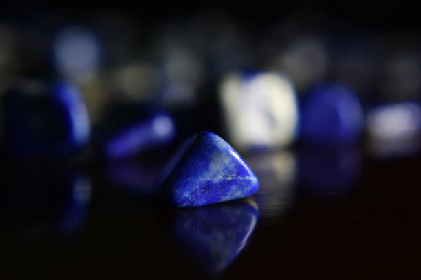 istock Lapis Is a beautiful natural gemstone on a wooden floor 1264166684