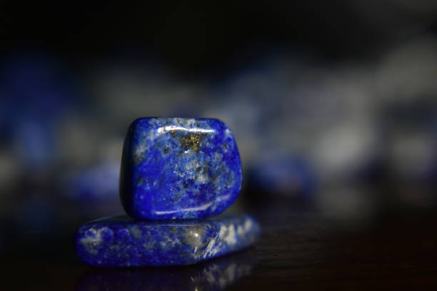 istock Lapis Is a beautiful natural gemstone on a wooden floor 1264166754