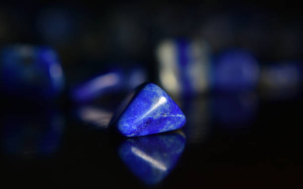 istock Lapis Is a beautiful natural gemstone on a wooden floor 1264166755