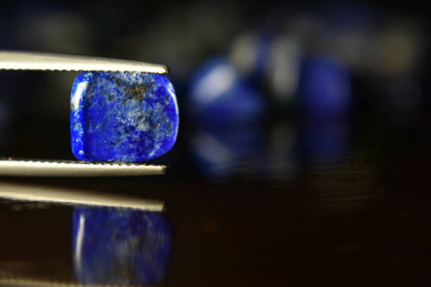 istock Lapis Is a beautiful natural gemstone on a wooden floor 1264166841