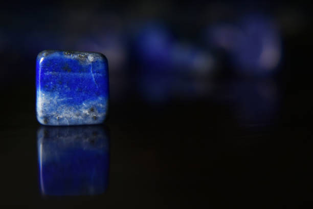 istock Lapis Is a beautiful natural gemstone on a wooden floor 1264166947