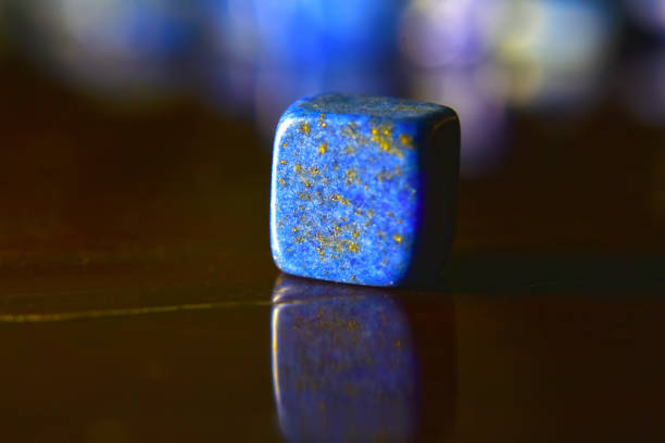 istock Lapis Is a beautiful natural gemstone on a wooden floor 1264167613